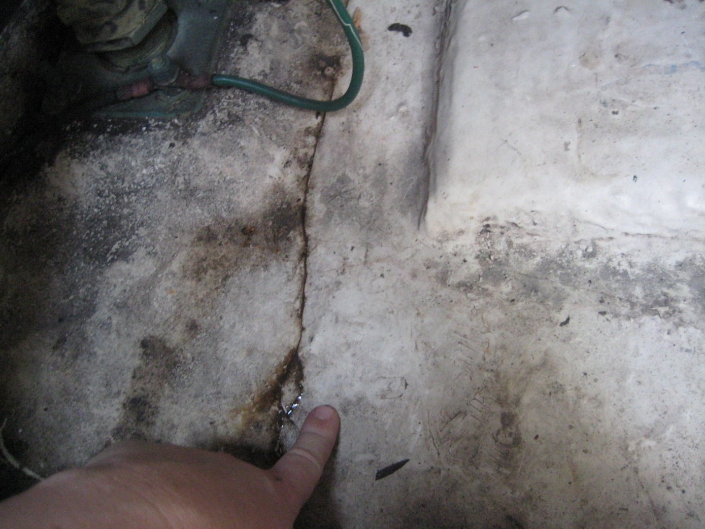 Surveyor pointing to crack in fiberglass hull